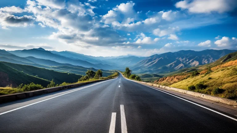 A long asphalt road through hills and mountains