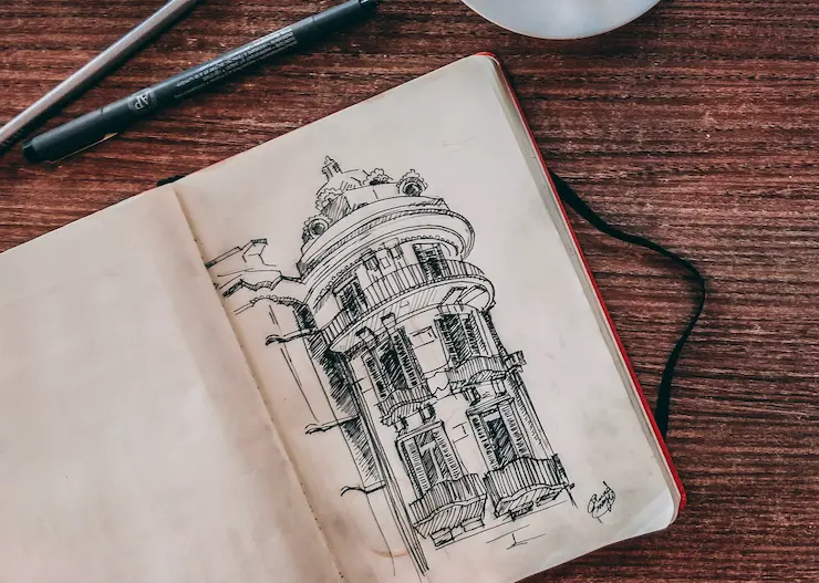 25 examples of art techniques: A comprehensive guide for art students and aspiring artists 2 A nice building sketch on a wooden desk